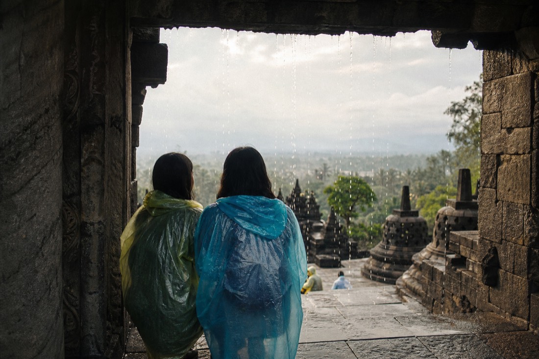 Sheltering from a downpour under a gateway of Borobudur