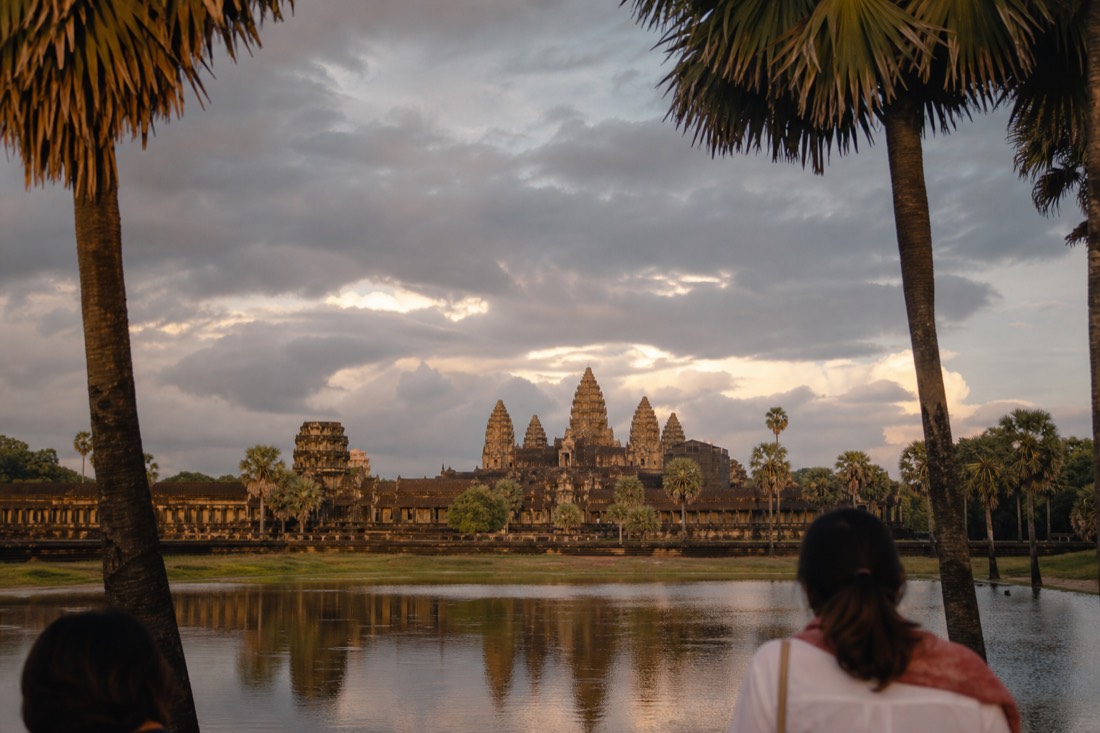 Angkor Wat across its moat under monsoon clouds