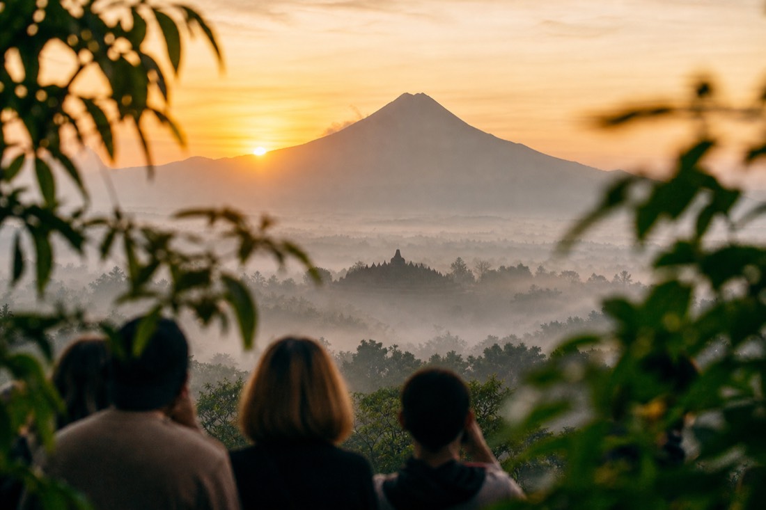 Sunrise beside Mount Merapi seen from Punthuk Setumbu, Borobudur in the mist below