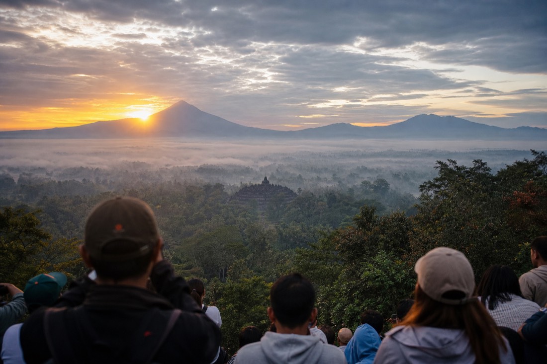 Sunrise beside Mount Merapi seen from Punthuk Setumbu, Borobudur in the mist below