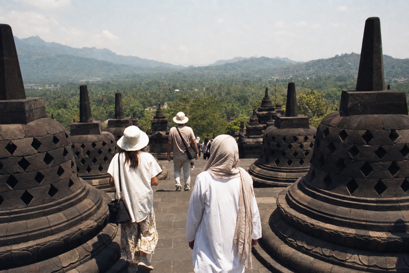 Visitors in light tropical clothing on the terraces of Borobudur