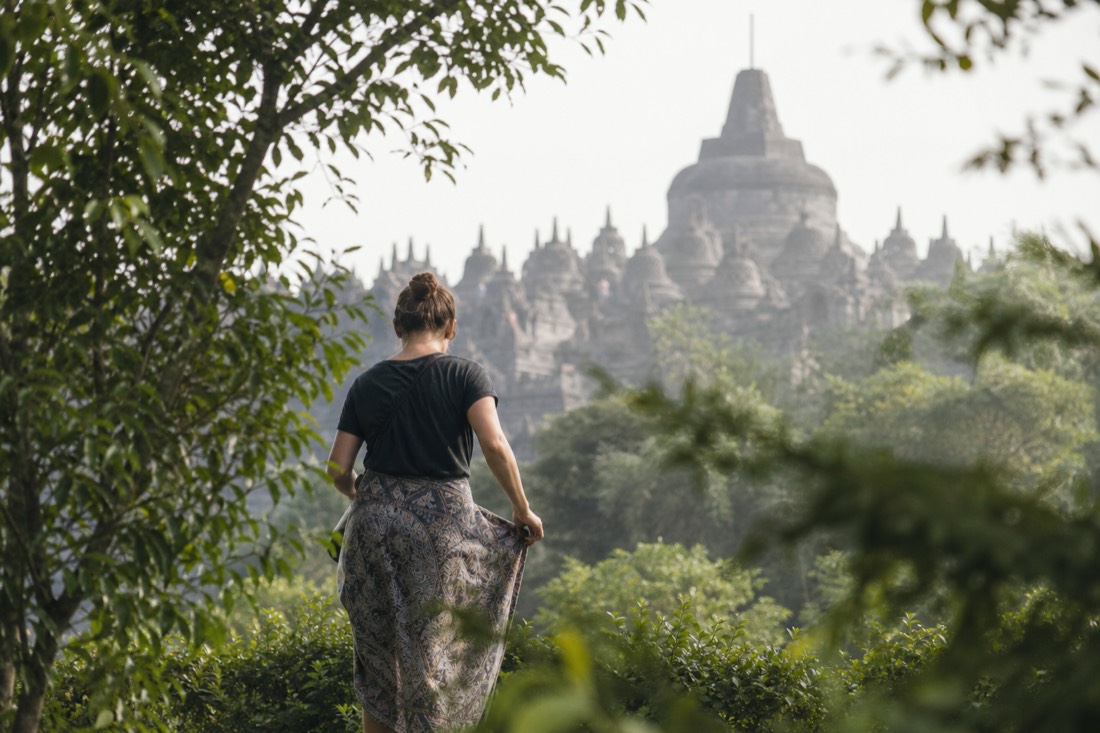 A visitor adjusting a sarong at Borobudur