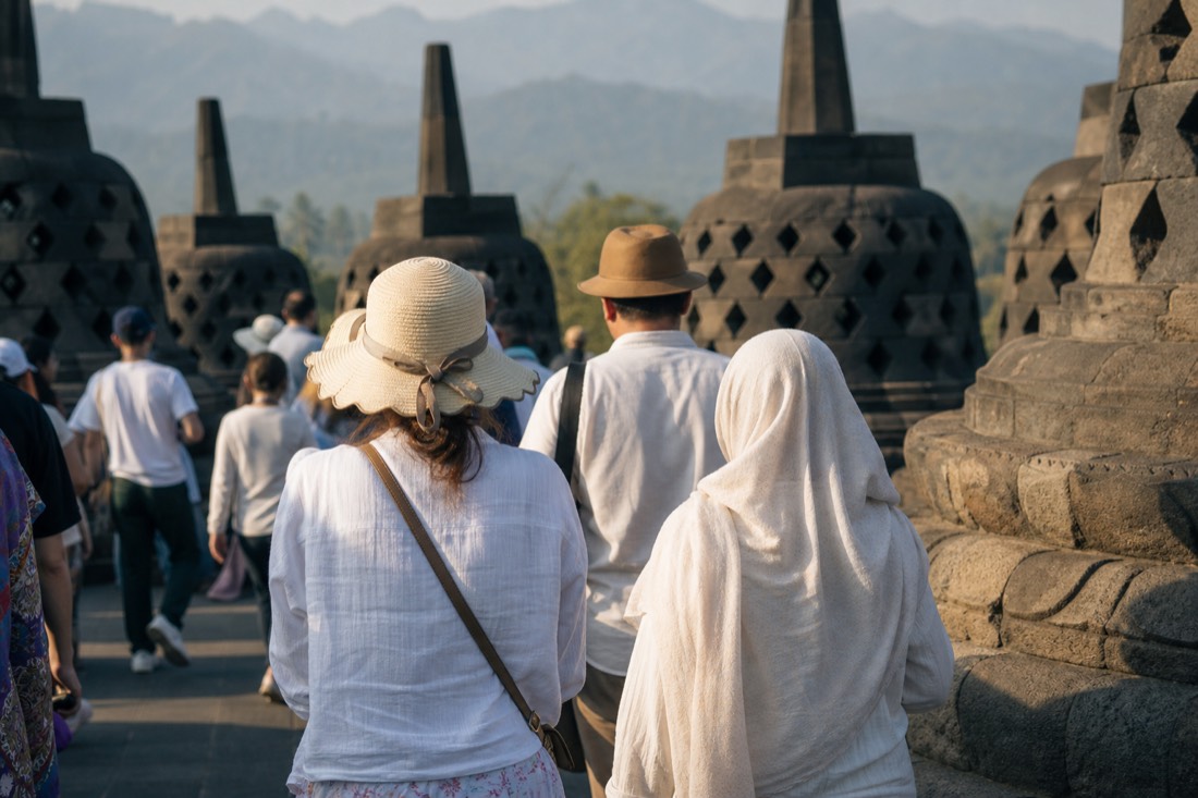 Visitors in light tropical clothing on the terraces of Borobudur