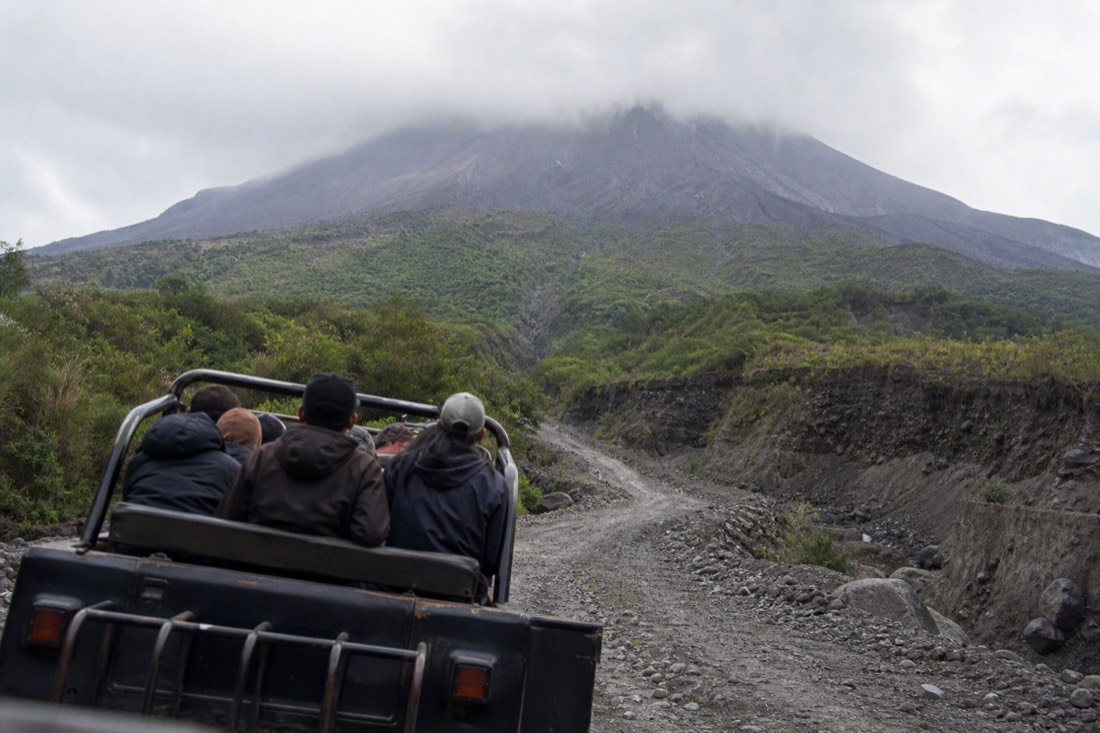 A jeep tour climbing the volcanic slopes of Mount Merapi