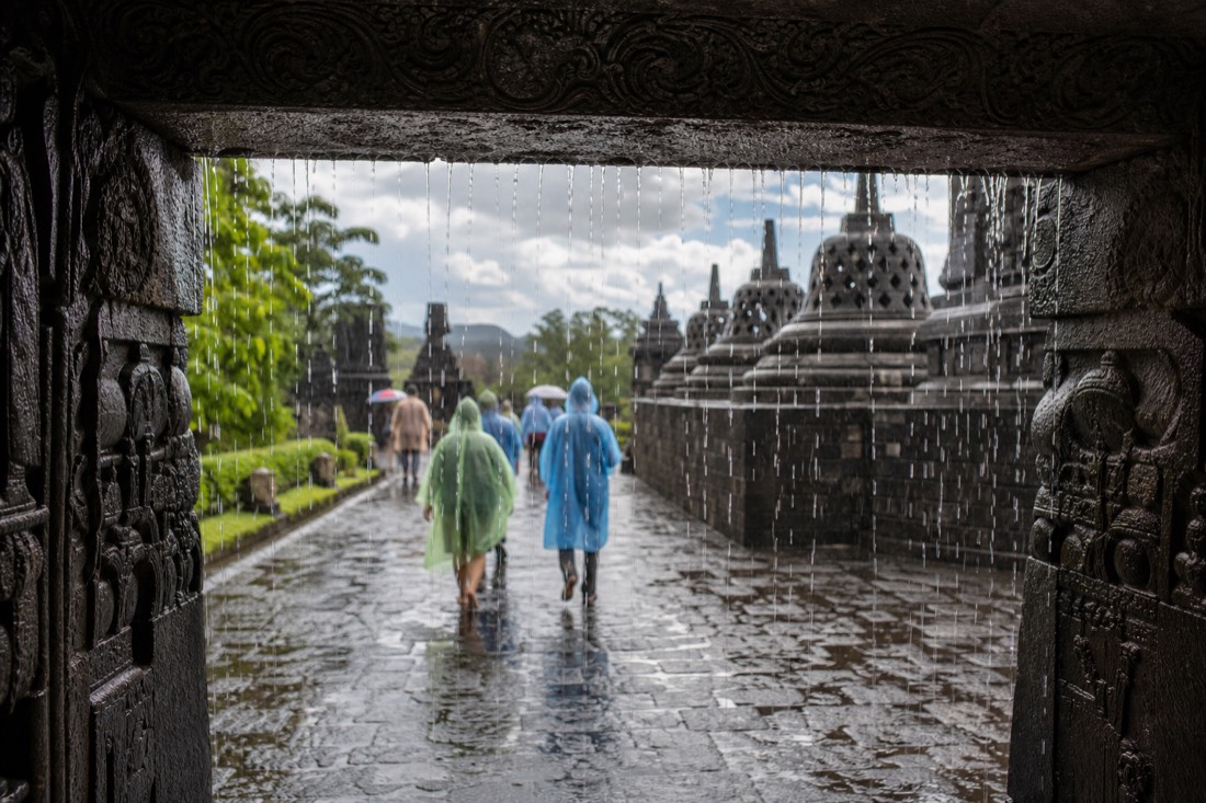 Sheltering from a downpour under a gateway of Borobudur