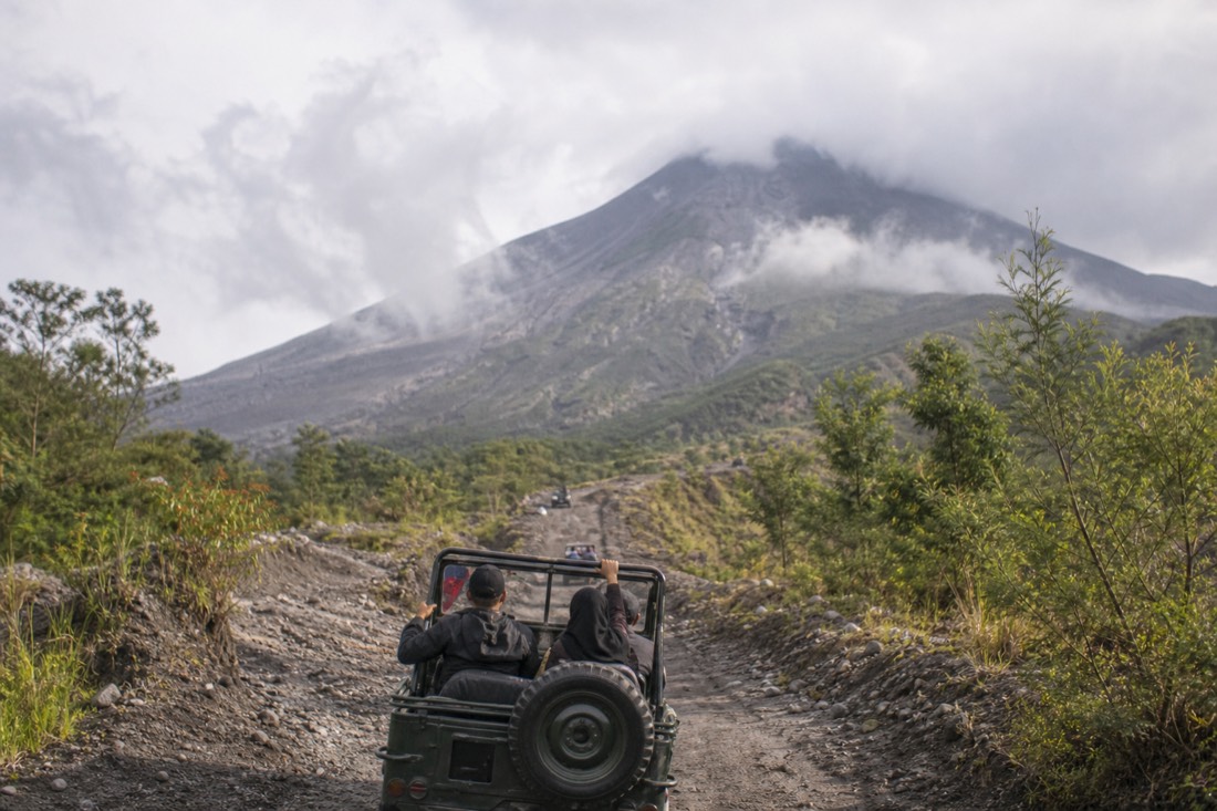 A jeep tour climbing the volcanic slopes of Mount Merapi