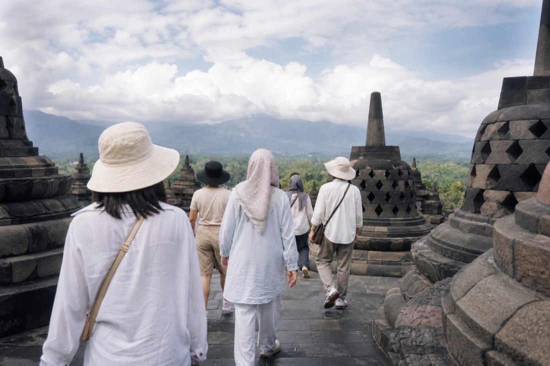 Visitors in light tropical clothing on the terraces of Borobudur